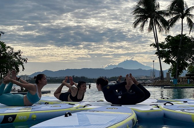 Zen & Splash: Stand-Up Paddleboard (SUP) Yoga in Tanjung Aru - Standing poses bring the playful challenge